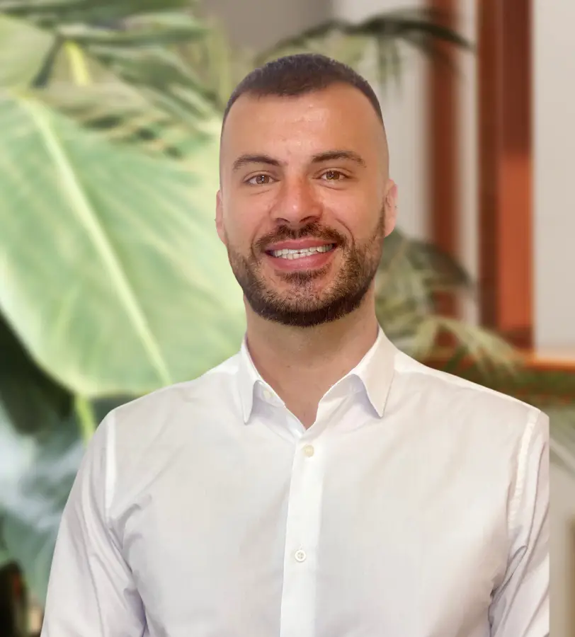 A bearded man in a white shirt