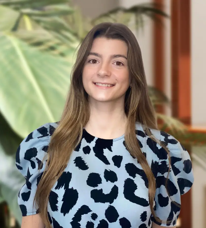 A brunette woman in a blue leopard print top