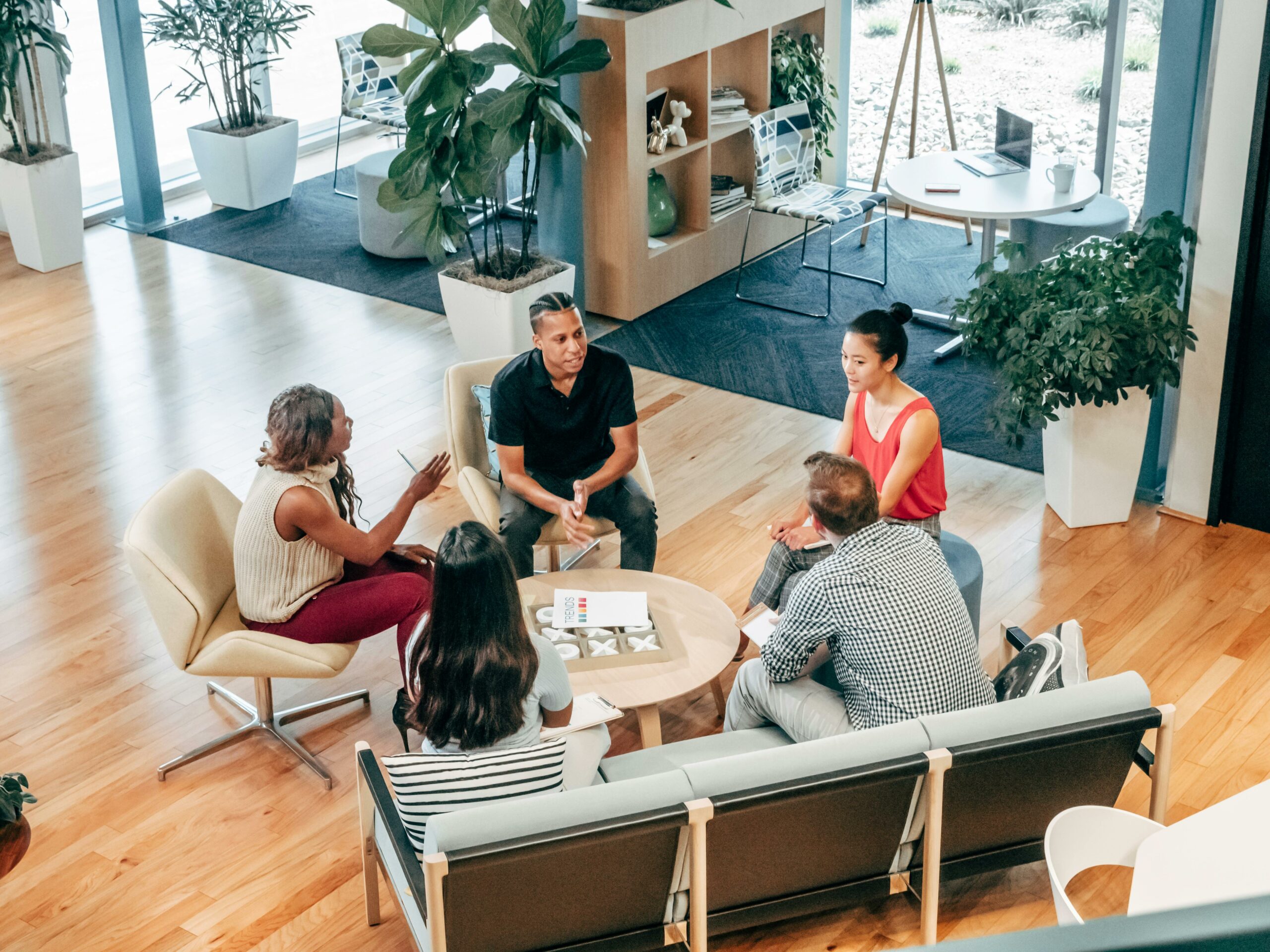 A group of people in a modern office sat down having a brainstorm.