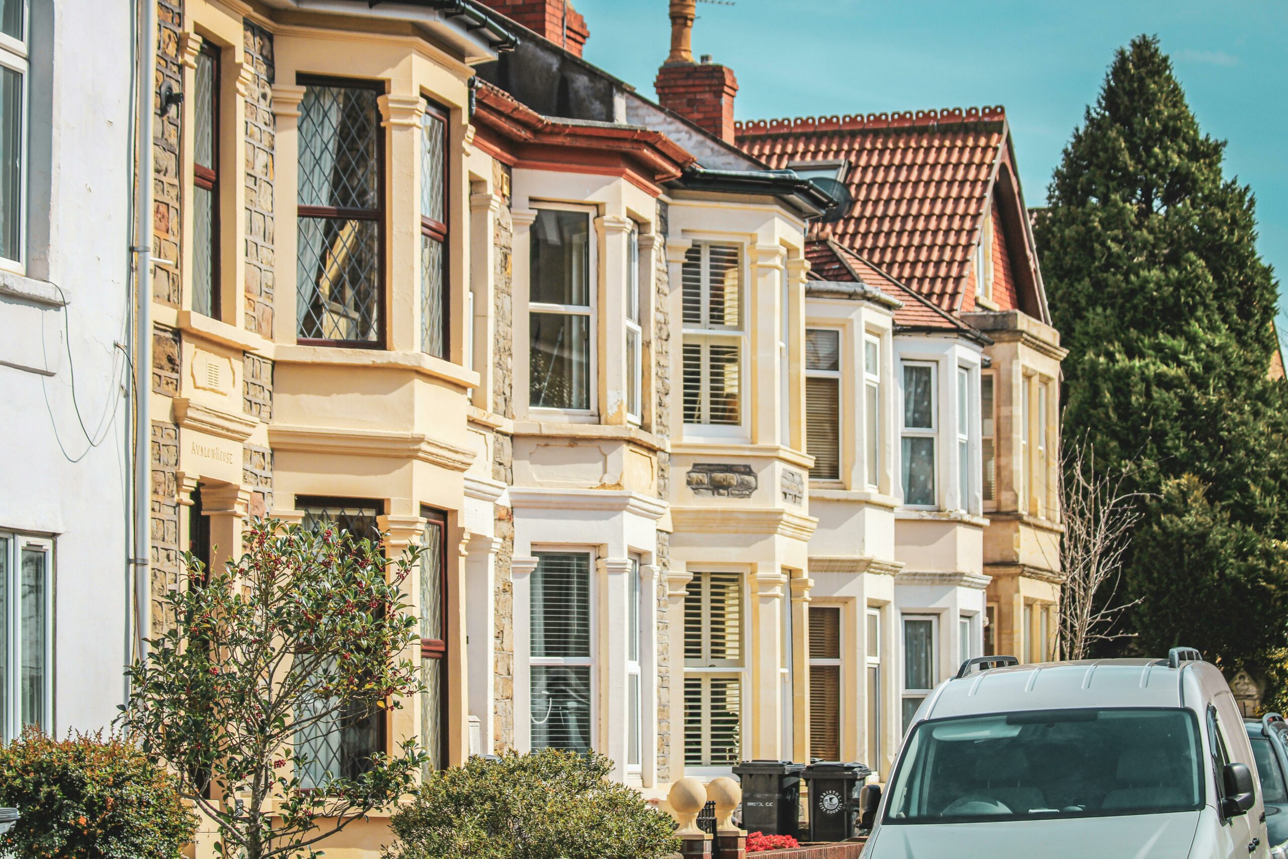 A row of terraced houses on a street.